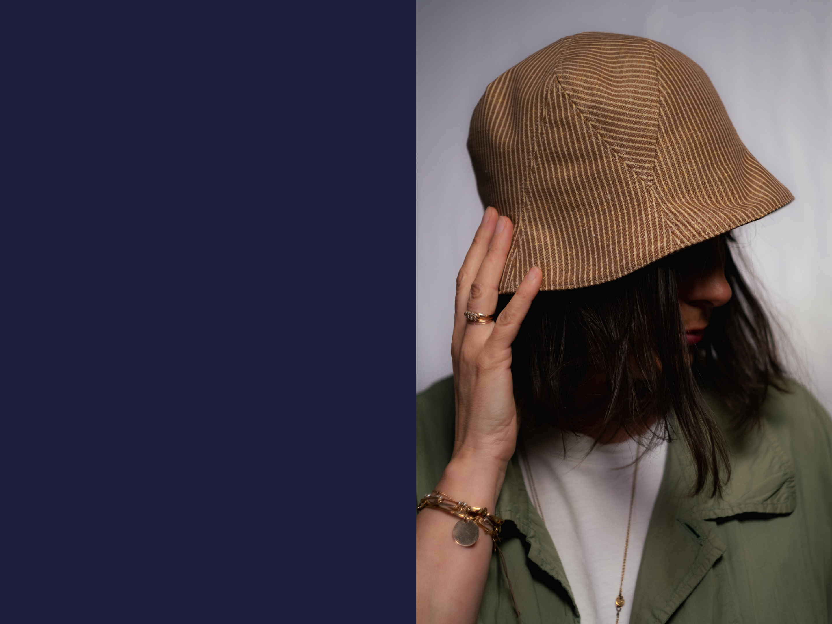 Juliette is wearing a Le Panache Paris© bucket hat made in France with tobacco and ivory stripeweave100% cotton.